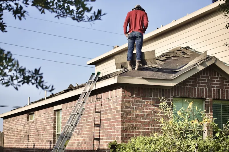 Professional roofer working on a residential roof in Salton City